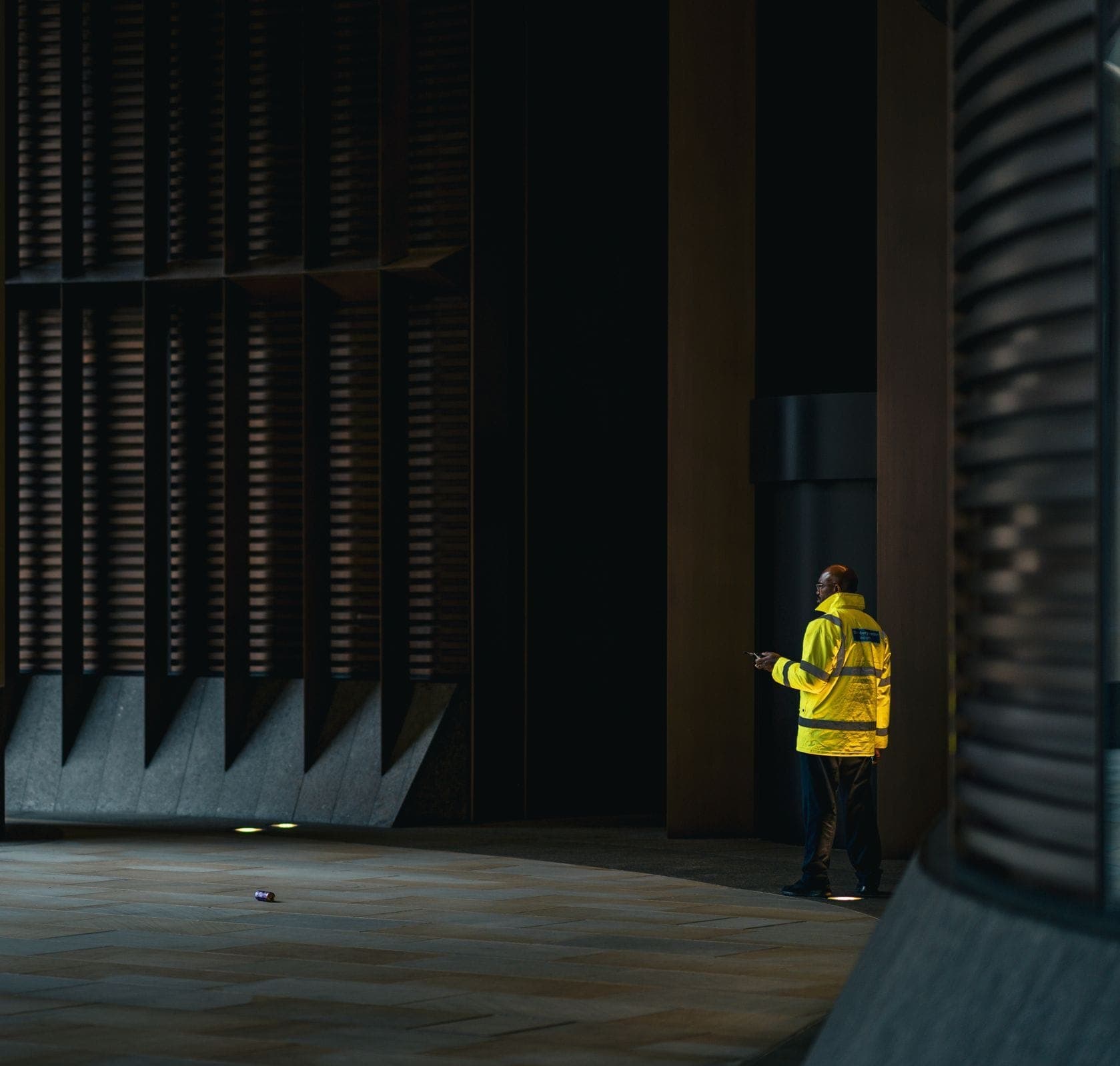 A security officer at a corporate reception desk